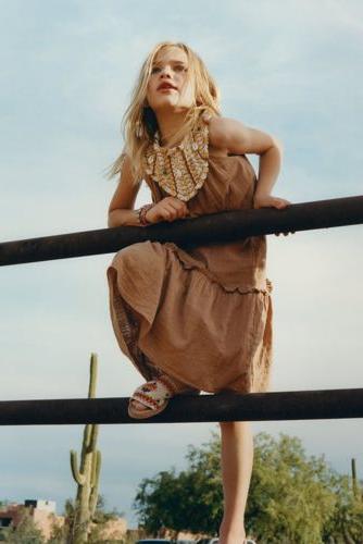 woman leaning on fence